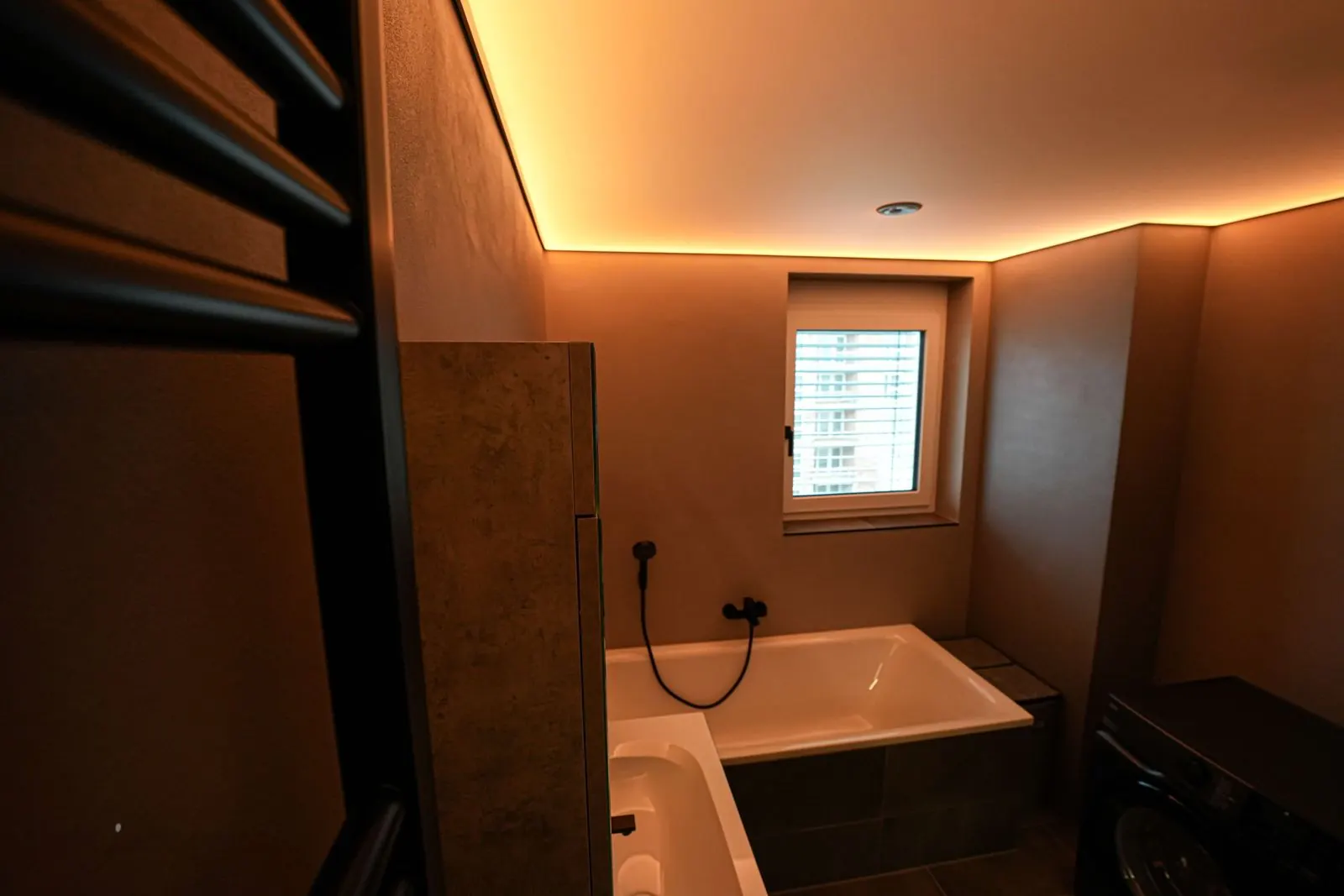 Bad mit Spanndecke in warmweißem Licht