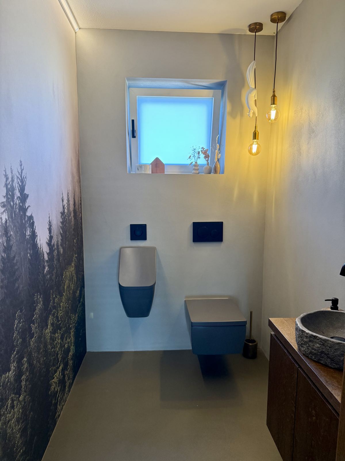 WC mit Wald-Wandbild und blauem Waschtisch